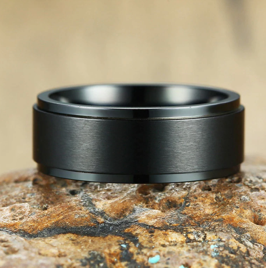 The Axis Spinner – Flat Steel Spinner Ring-Engineered for focus and style—Axis Spinner Ring. 8mm brushed steel band with free-spinning outer ring. Bold design with calming motion. Shop now.