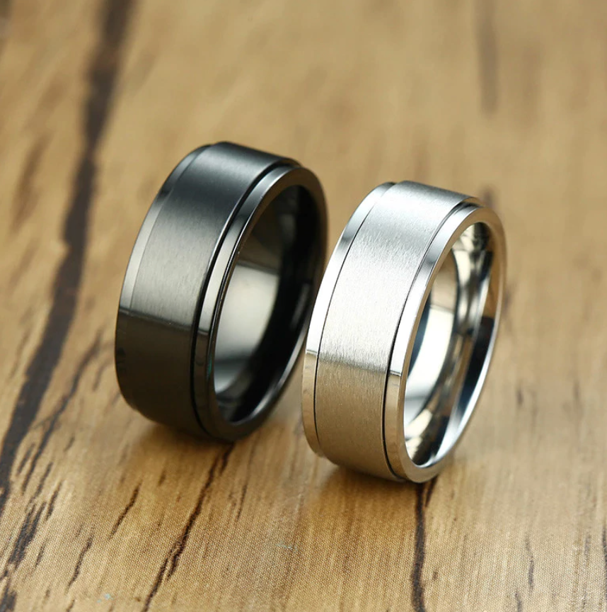 The Axis Spinner – Flat Steel Spinner Ring-Engineered for focus and style—Axis Spinner Ring. 8mm brushed steel band with free-spinning outer ring. Bold design with calming motion. Shop now.