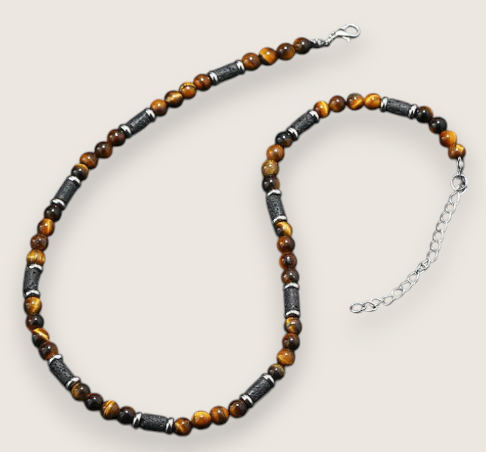 The Ember Forge –Stone & Lava Rock Necklace-Channel primal heat with the Ember Forge Necklace. Tiger eye beads, lava-stone cylinders, and silver spacers—warm, rugged contrast. Adjustable length. Shop now.
