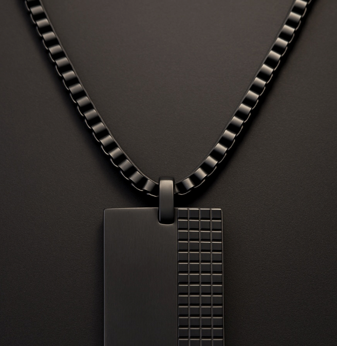 The Obsidian Grid – 40 mm Oxidized Dog Tag Necklace-Strike bold balance with the Obsidian Grid Tag. Black steel dog tag with brushed and grid-textured finish on a chain. Industrial edge meets style. Shop now.