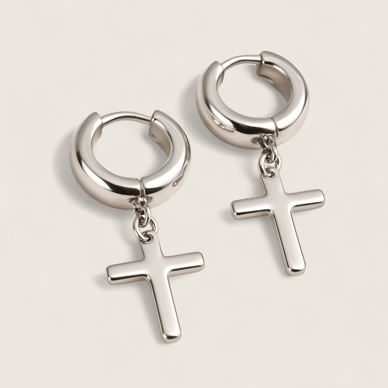 The Creed - Cross Dangle Huggies Earrings-Forge bold style with the Creed Cross Huggies. Polished steel small hoops with dangling cross pendants. Available in steel or gold. Shop now.
