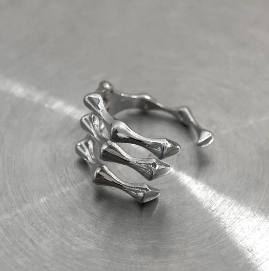 The Ossuary – Triple Bone Band-Bring a spine-tingling edge with the Ossuary Band. Sculpted steel bone-bar arches, bold open-band design, and darkened details. Shop now.