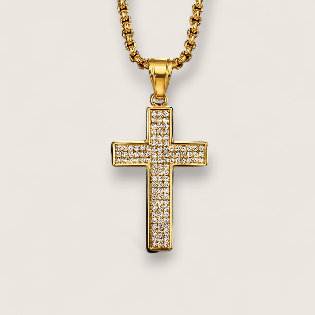 Gold cross pendant with diamonds on a light gray background