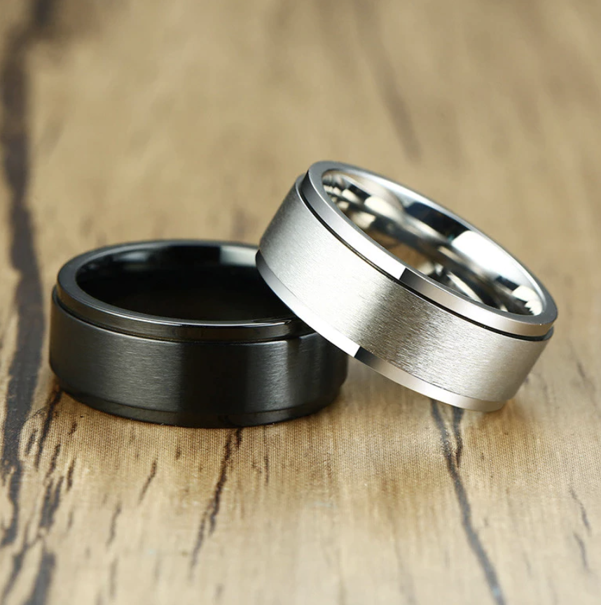 The Axis Spinner – Flat Steel Spinner Ring-Engineered for focus and style—Axis Spinner Ring. 8mm brushed steel band with free-spinning outer ring. Bold design with calming motion. Shop now.