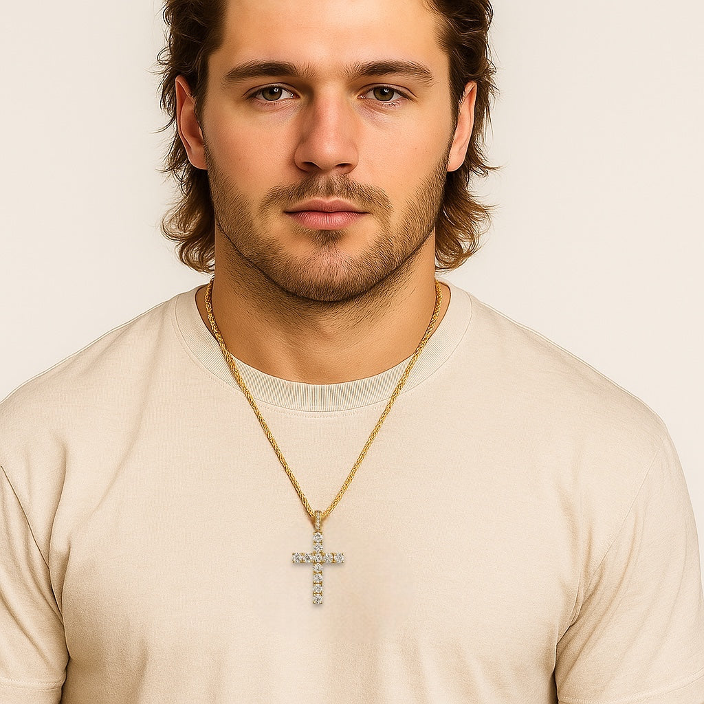 Man wearing a gold necklace with a cross pendant on a plain background