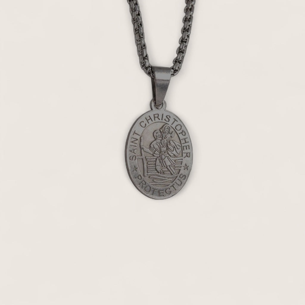 Saint Christopher pendant on a chain against a light gray background
