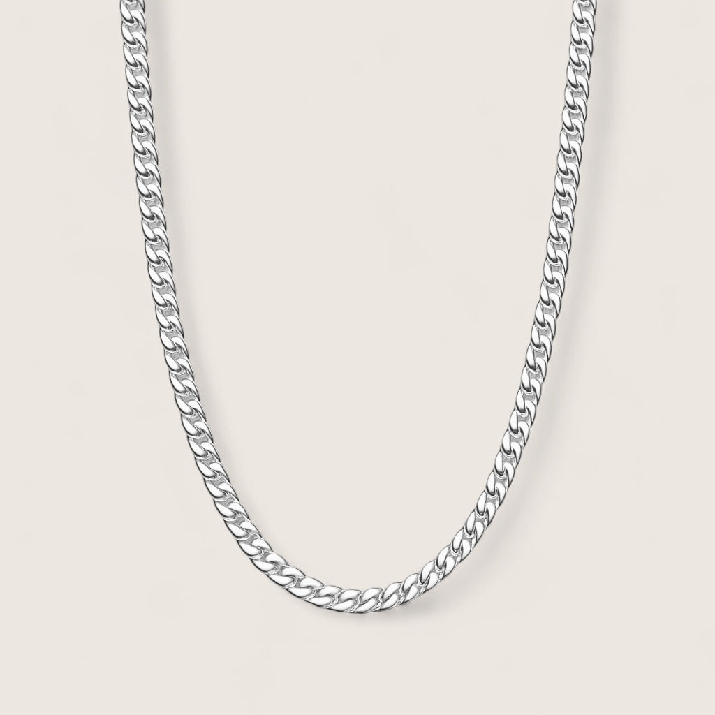 Silver chain necklace on a light gray background