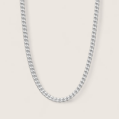 Silver chain necklace on a light gray background