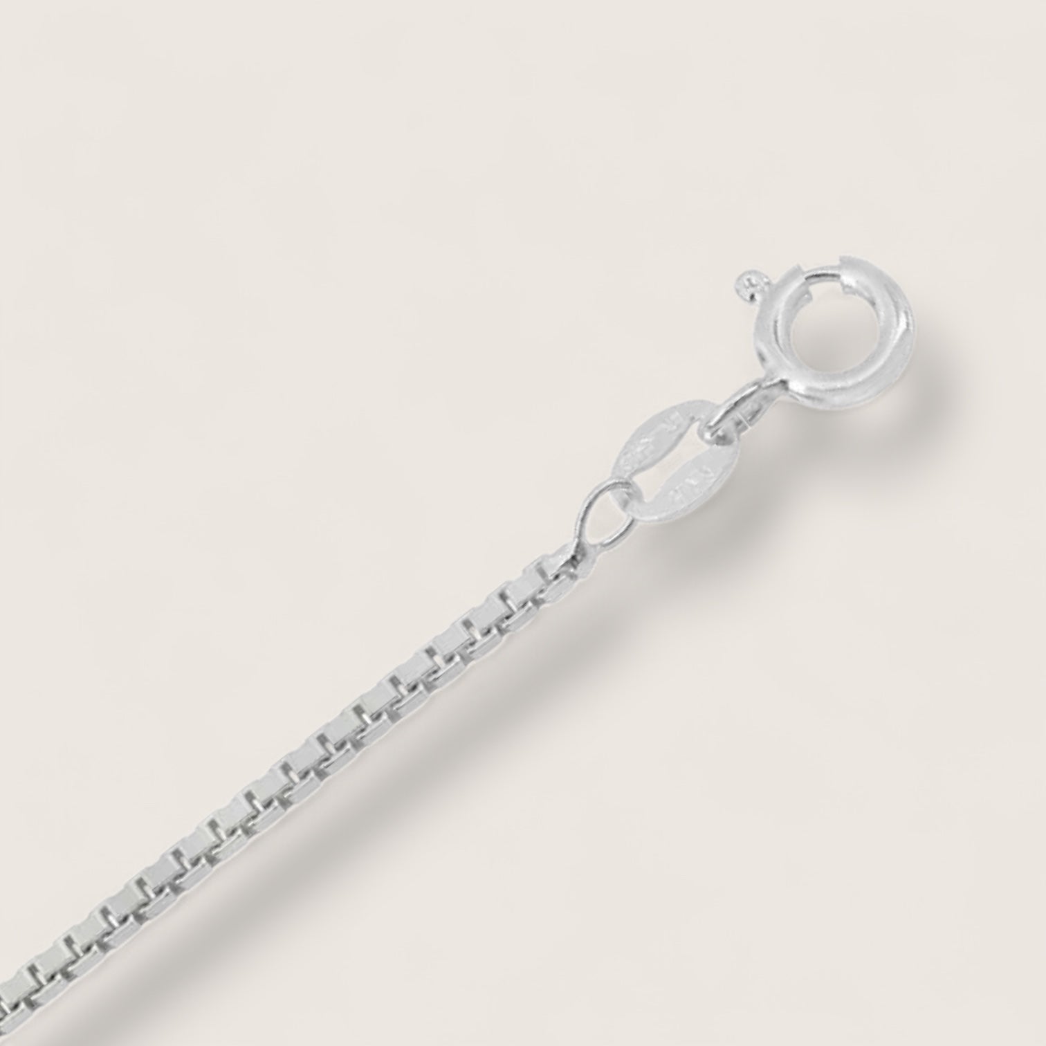 Silver bracelet on a light gray background