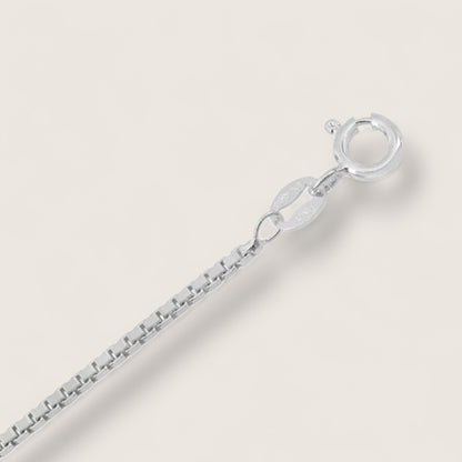 Silver bracelet on a light gray background