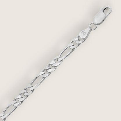 The Argent Figaro – 5.7mm Sterling Silver Chain-Bold 5.7mm sterling silver Figaro chain, diamond-cut for texture and shine. Crafted in Italy. A timeless statement piece. Shop now.