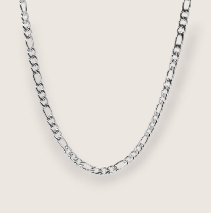 Silver chain necklace on a light gray background