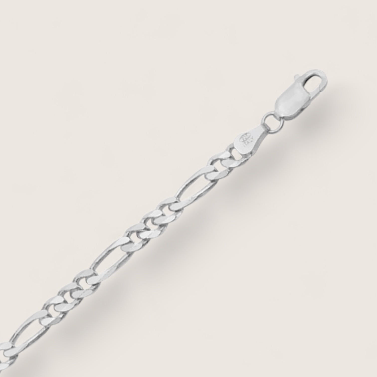 Silver chain bracelet on a light beige background