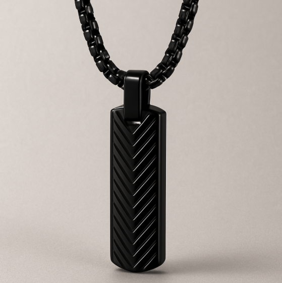 The Axis – Steel Bar Necklace-Elevate your look with the Axis Pendant. Sleek steel bar with chevron-textured detail in polished silver or matte black. Minimal, modern style. Shop now.