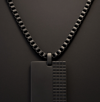The Obsidian Grid – 40 mm Oxidized Dog Tag Necklace-Strike bold balance with the Obsidian Grid Tag. Black steel dog tag with brushed and grid-textured finish on a chain. Industrial edge meets style. Shop now.