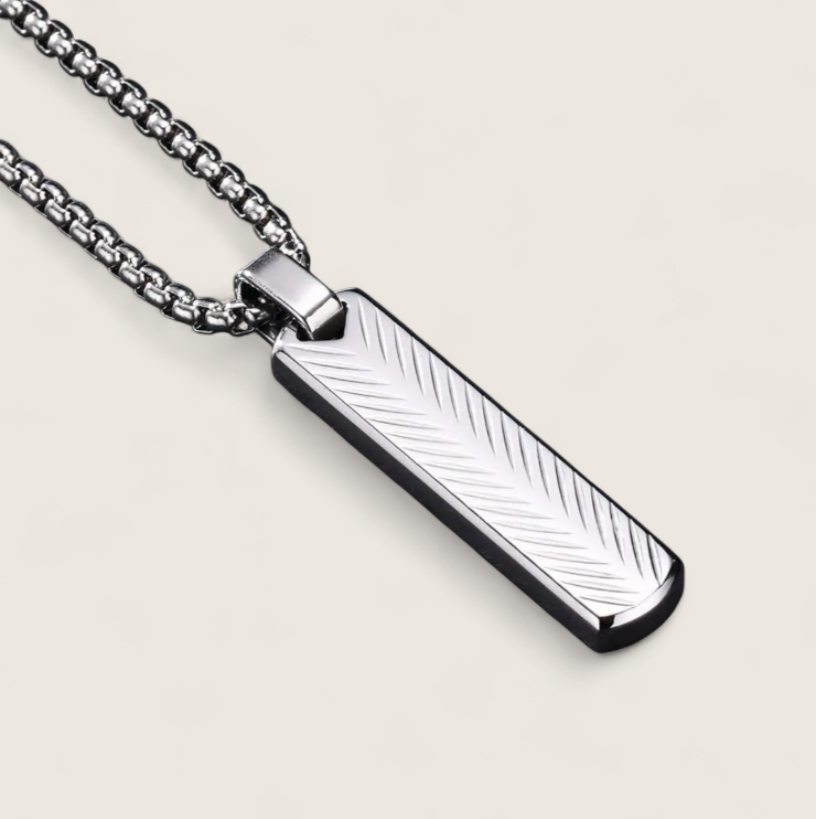 The Axis – Steel Bar Necklace-Elevate your look with the Axis Pendant. Sleek steel bar with chevron-textured detail in polished silver or matte black. Minimal, modern style. Shop now.