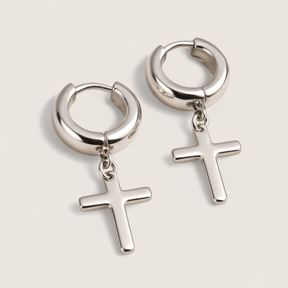 The Creed - Cross Dangle Huggies Earrings-Forge bold style with the Creed Cross Huggies. Polished steel small hoops with dangling cross pendants. Available in steel or gold. Shop now.