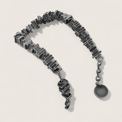 The Relic – Antique-Geometric Steel Bracelet-Channel industrial heritage with the Relic Bracelet. Aged steel segments with antique patina evoke rugged refinement and bygone craftsmanship. Shop now.