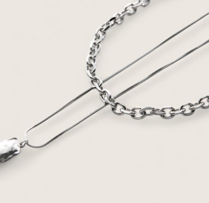 Molten Arc Duo Necklace-Fuel your look with layered steel chains and molten nugget pendant. Bold Voltage style with adjustable curb and snake chains. Shop now.