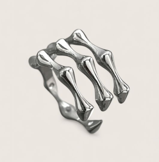 The Ossuary – Triple Bone Band-Bring a spine-tingling edge with the Ossuary Band. Sculpted steel bone-bar arches, bold open-band design, and darkened details. Shop now.