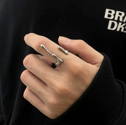 Reactor Drip – Statement Ring-Channel raw energy with the Reactor Drip Ring. Polished steel, sculptural open-band design with opposing arcs. Adjustable fit. Shop now.