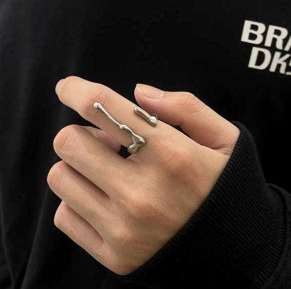 Reactor Drip – Statement Ring-Channel raw energy with the Reactor Drip Ring. Polished steel, sculptural open-band design with opposing arcs. Adjustable fit. Shop now.