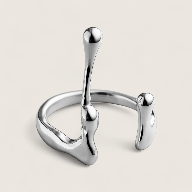 Reactor Drip – Statement Ring-Channel raw energy with the Reactor Drip Ring. Polished steel, sculptural open-band design with opposing arcs. Adjustable fit. Shop now.