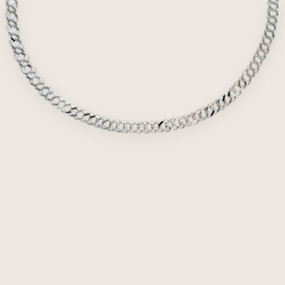 Silver chain necklace on a light gray background