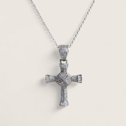 Silver cross pendant necklace on a light gray background