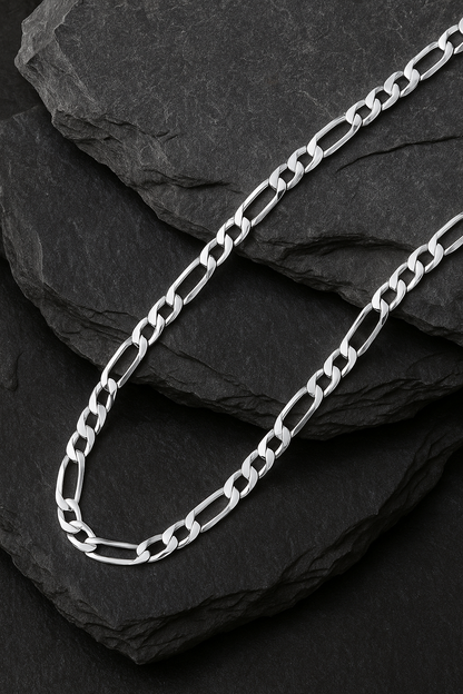 The Argent Figaro – 5.7mm Sterling Silver Chain-Bold 5.7mm sterling silver Figaro chain, diamond-cut for texture and shine. Crafted in Italy. A timeless statement piece. Shop now.