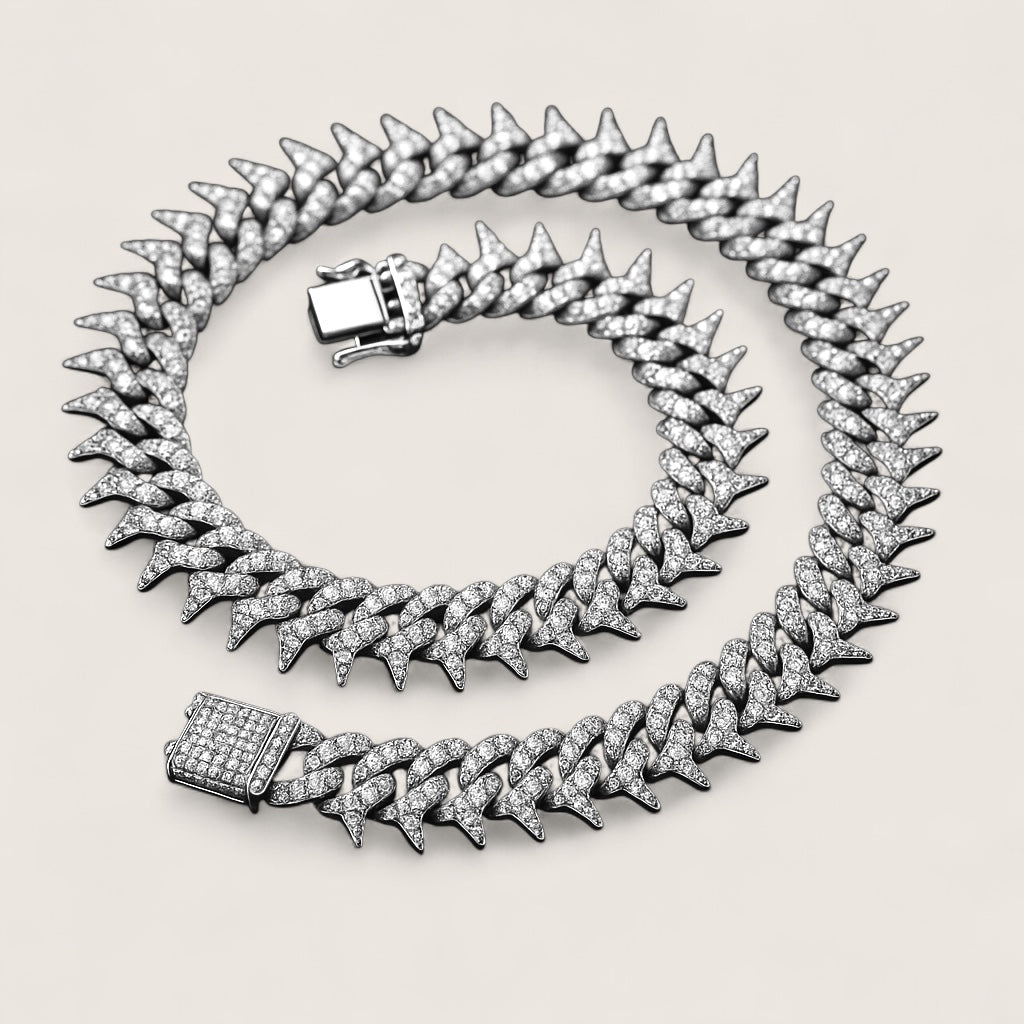 The Frostbite – 22″ Spiked Iced Cuban Chain-Strike with Frostbite. 20mm iced Cuban chain with CZ stones and razor-edged links. 22" of bold, high-voltage energy and cold precision. Shop now.