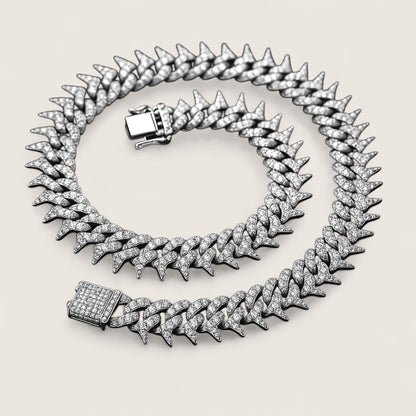 The Frostbite – 22″ Spiked Iced Cuban Chain-Strike with Frostbite. 20mm iced Cuban chain with CZ stones and razor-edged links. 22" of bold, high-voltage energy and cold precision. Shop now.