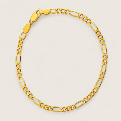 Gold chain bracelet on a light beige background