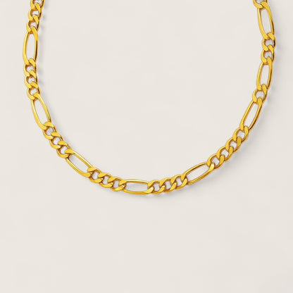 Gold chain necklace on a light gray background