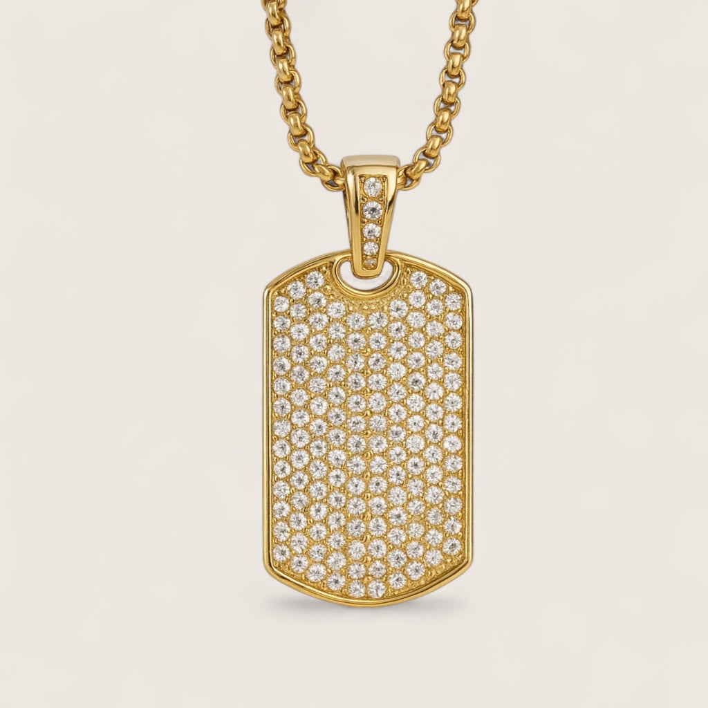 Gold pendant with diamond accents on a beige background