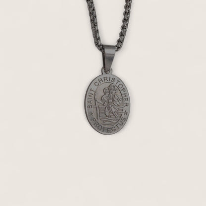 Saint Christopher pendant on a chain against a light gray background