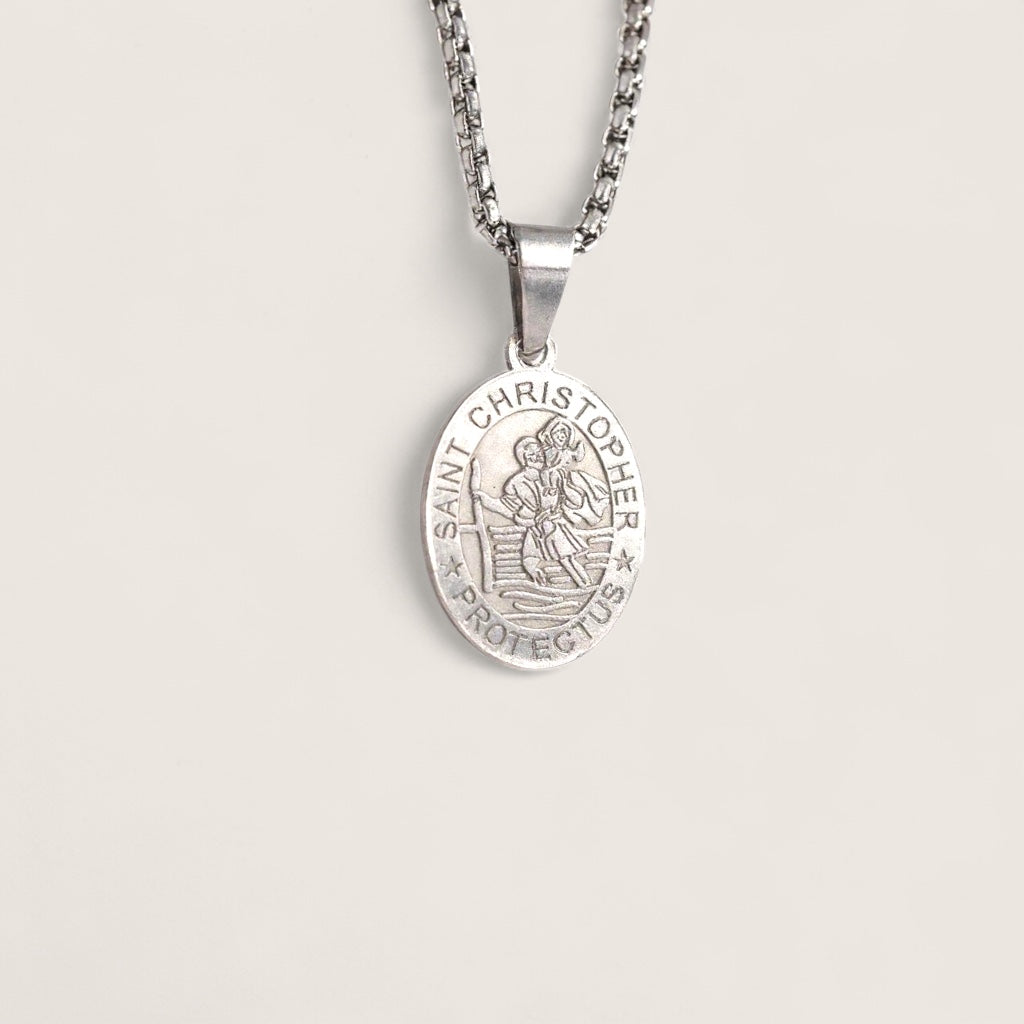 Silver Saint Christopher pendant on a chain against a light gray background