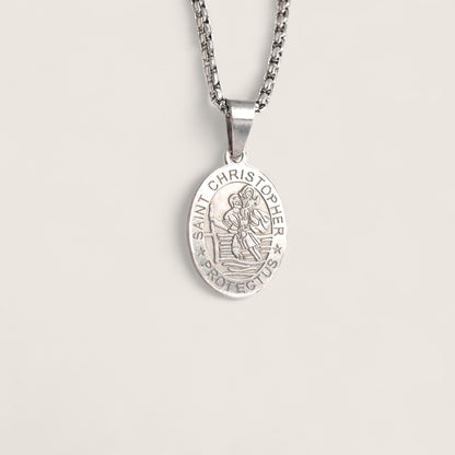 Silver Saint Christopher pendant on a chain against a light gray background