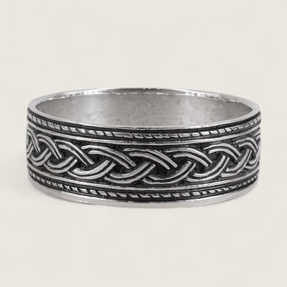Silver ring with braided design on a white background