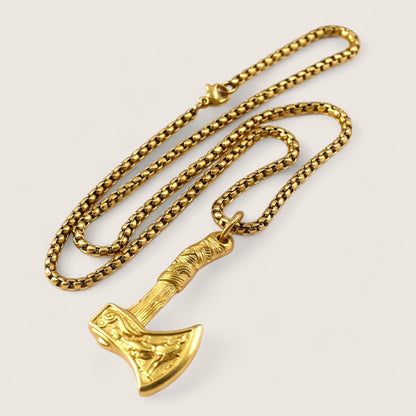 Gold axe pendant necklace on a light gray background