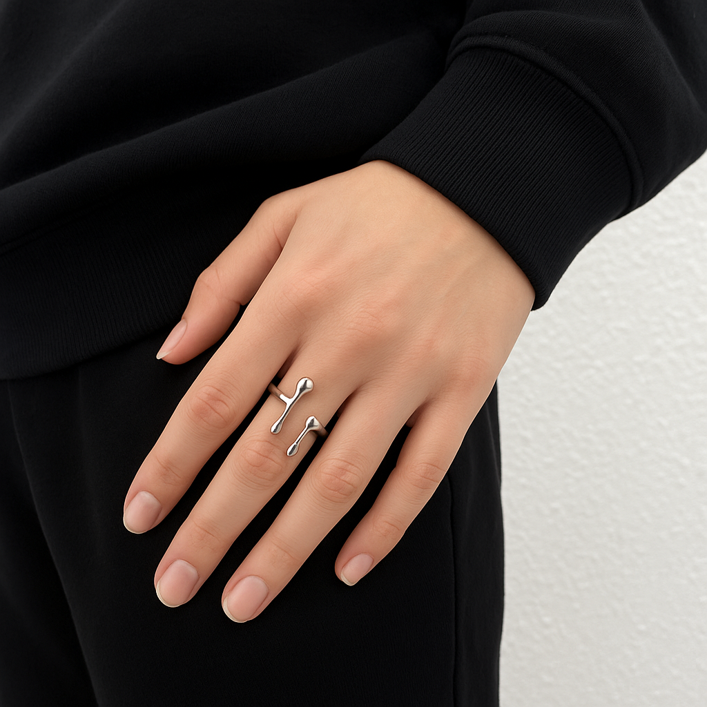 Reactor Drip – Statement Ring-Channel raw energy with the Reactor Drip Ring. Polished steel, sculptural open-band design with opposing arcs. Adjustable fit. Shop now.